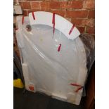 A curved cast resin shower tray, new, opened.