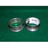 Two silver napkin rings.