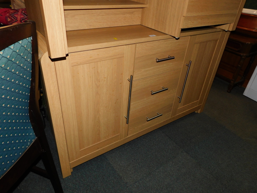 An oak effect sideboard with steel handles.