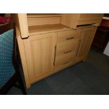 An oak effect sideboard with steel handles.