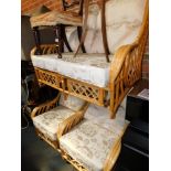 A bamboo three piece conservatory suite, upholstered in gold and cream brocade.