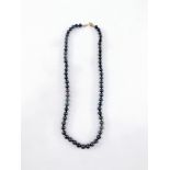 A black Akoya pearl necklace, with small black lustre finish beads, ranging from 6 to 6.5mm, with a