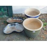 A pair of glazed plants pots (AF), together with a pair of cast iron drinking troughs converted to p
