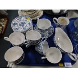 A blue and white English porcelain part tea service, with cups, saucers, mugs and a gravy boat. (1 t