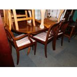 A reproduction mahogany dining table, together with five chairs. (6) The upholstery in this lot does