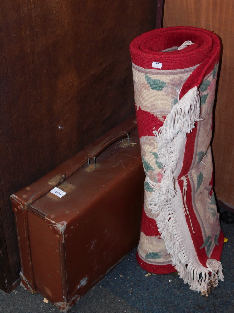 A tan leather travel trunk and a Chinese carpet. (2)