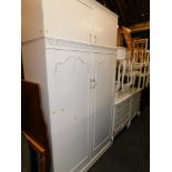 A French style cream painted bedroom suite, comprising two dressing tables and stools, two chests, w