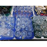 Various glassware, to include drinking glasses, champagne flutes, wine glasses, etc. (4 trays)