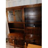 A pair of dark oak and lead glazed lounge units.