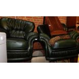 A pair of green leather armchairs.