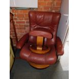 An Ekornes Stressless reclining armchair, in maroon leatherette, together with a matching footstool.