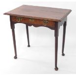 A George III oak and mahogany cross banded side table, with a single frieze drawer, raised on turned