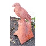 A terracotta ridge tile, surmounted with a bird of prey, 55cm high. (AF)