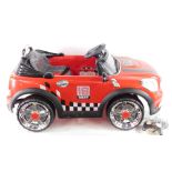 A Classic 16 Baby Remote Controlled Electric Pedal Mini Cooper Car, in red, with control.