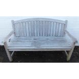 A slatted garden bench with shaped arched back, on block supports joined by vertical stretchers, 150