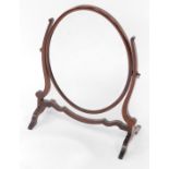 An Edwardian mahogany swing frame toilet mirror, inset oval bevelled glass, within a show frame, 56c