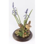 A Country Artists sculpture of a wren, amongst lavender, raised on a stepped circular base.