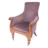 A William IV mahogany armchair, upholstered in striped purple fabric, raised on turned legs, brass c