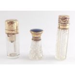 An Edward VII cut glass scent bottle, with silver mounted hinged lid, embossed with foliate scrolls,