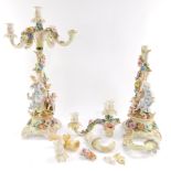 A pair of continental late 19thC porcelain candelabrum, of four branch form, encrusted with flowers,