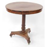 A Regency rosewood occasional table, the circular top over a fluted and lappet carved column above a