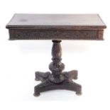 A Victorian stained oak fold over card table, with a vine carved frieze, over an urn and fluted colu