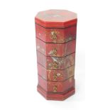 A Chinese red lacquer octagonal chest, of five drawers, raised on a plinth base, decorated with bird
