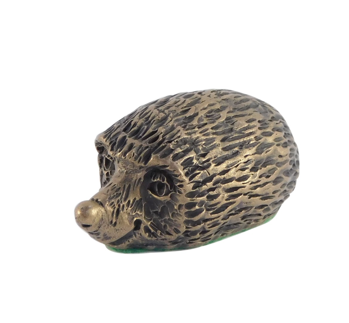 A bronze figure of a hedgehog, 7cm wide.