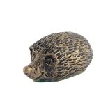 A bronze figure of a hedgehog, 7cm wide.