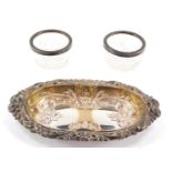 A silver plated pin dish and a pair of cut glass and silver rimmed salts, the plated pin dish with o