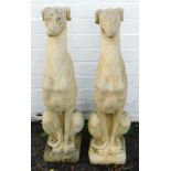 A pair of reconstituted stone figures of greyhounds, modelled seated on a square base, 76cm high.