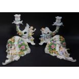 A pair of Sitzendorf 20thC porcelain wall shelves, of rococo form, encrusted with flowers and surmou