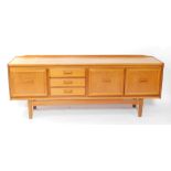 A William Lawrence of Nottingham mid century teak sideboard, with an arrangement of three cupboard d