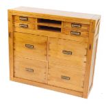 An oak desk or bureau, with a hinged top section, above an arrangement of two small drawers, and rec