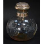 An Edward VII cut glass scent bottle, with silver mount and hinged lid, embossed with flowers, shiel