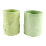 Two Chinese green glazed brush pots, of cylindrical form, one moulded with horses in a landscape, be