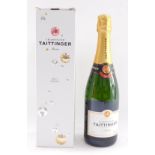 A bottle of Taittinger champagne, boxed.