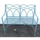 A green metal two seater garden bench, 102cm wide.