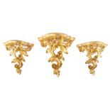 Three giltwood rococo style wall shelves, with serpentine shaped shelves over foliate scroll support