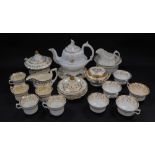 A group of early 19thC porcelain tea wares, gilt decorated with flowers, including a teapot, sucrier
