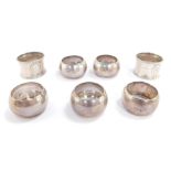 A set of four George V silver napkin rings, Birmingham 1915, a pair of Victorian napkin rings, embos