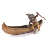 A Franz Bergman style cold painted bronze model of a Native American Indian, seated in a canoe, impr