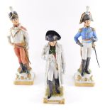 A Capodimonte porcelain figure modelled as Napoleon, 24cm high, and two figures of Napoleonic soldie