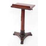 A Victorian mahogany reading lectern, raised on an adjustable turned and lappet carved column, over