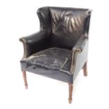 An early 19thC mahogany and studded black leather wing back armchair, raised on turned legs, 83cm wi