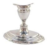 A George V silver candlestick of elliptical form raised on a stepped base, Chester 1913, 10.5cm high