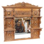 A Victorian oak overmantel mirror, the pediment carved with the head of a lion and foliate scrolls,