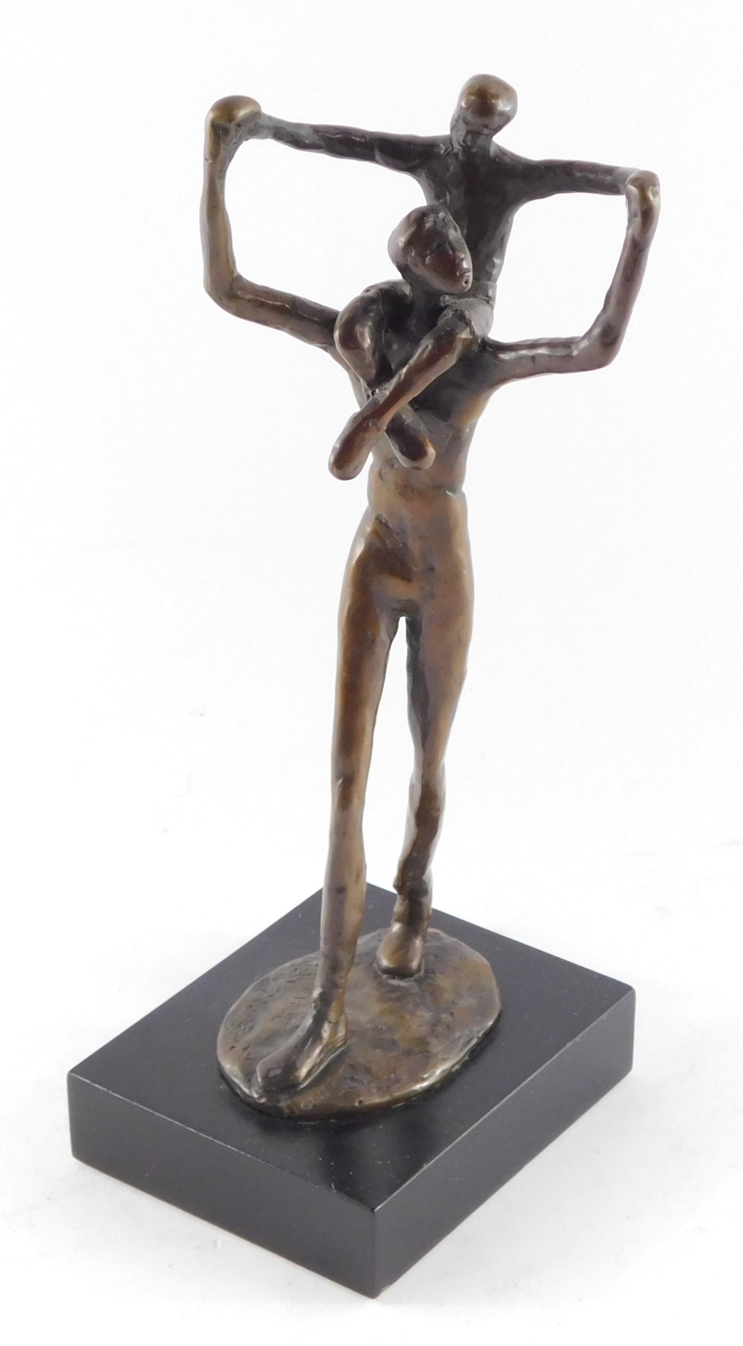 A bronze figure of a father modelled standing with a child on his shoulders, bears signature, raised