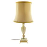 An onyx and brass table lamp, of baluster vase shape form, raised on a square base, with shade, 63cm