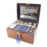 A Victorian rosewood fitted vanity box, containing cut glass bottles, jars and boxes with plated lid